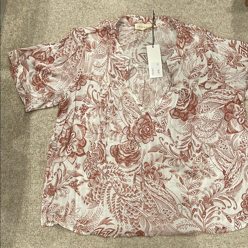 Women’s size medium short sleeve dressy t-shirt.  New with tags.